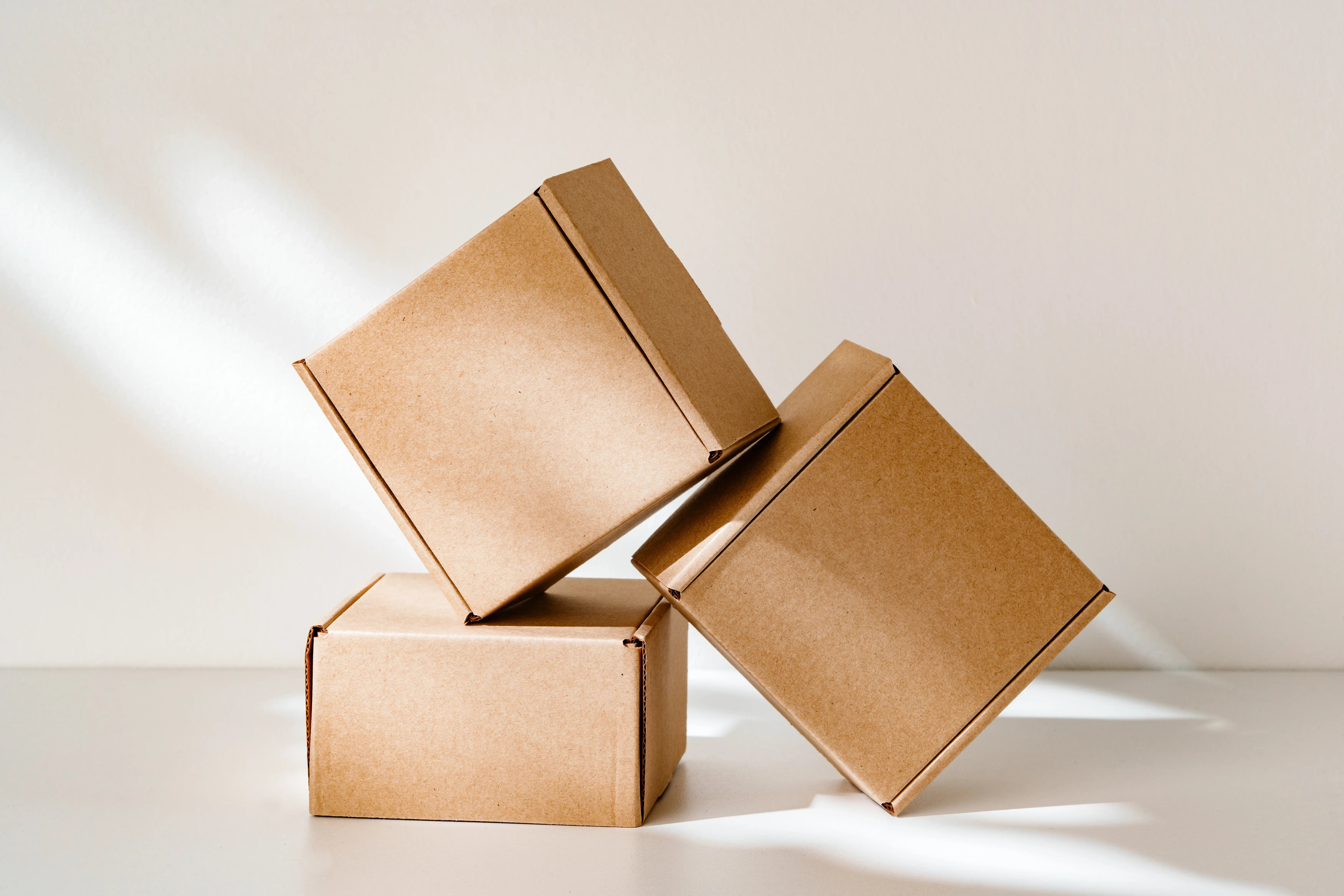 stacked-cardboard-boxes-with-shadows-on-white-back-2026-03-19-05-10-44-utc