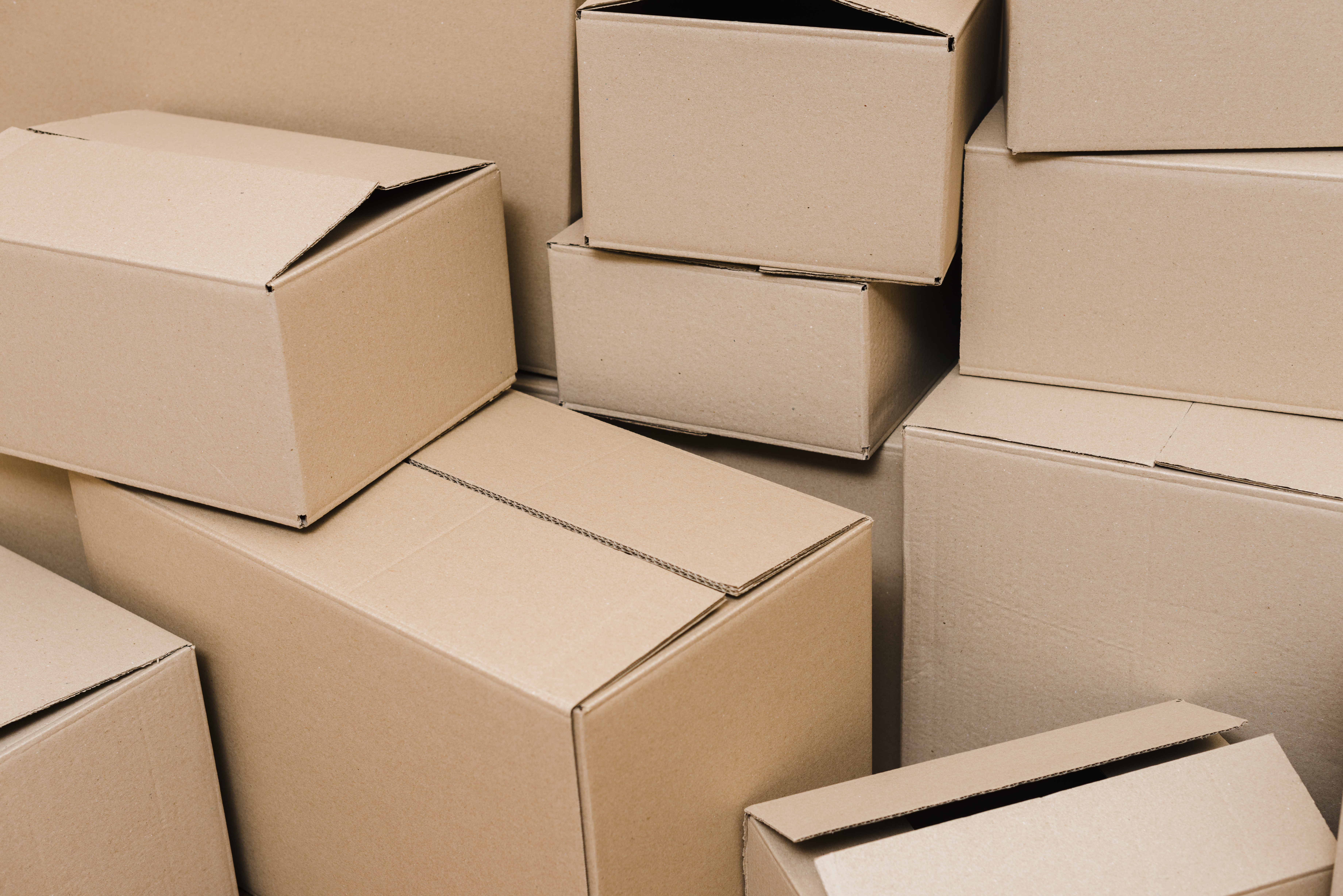Close-up of various sized corrugated cardboard boxes stacked together from quality packaging box manufacturers.