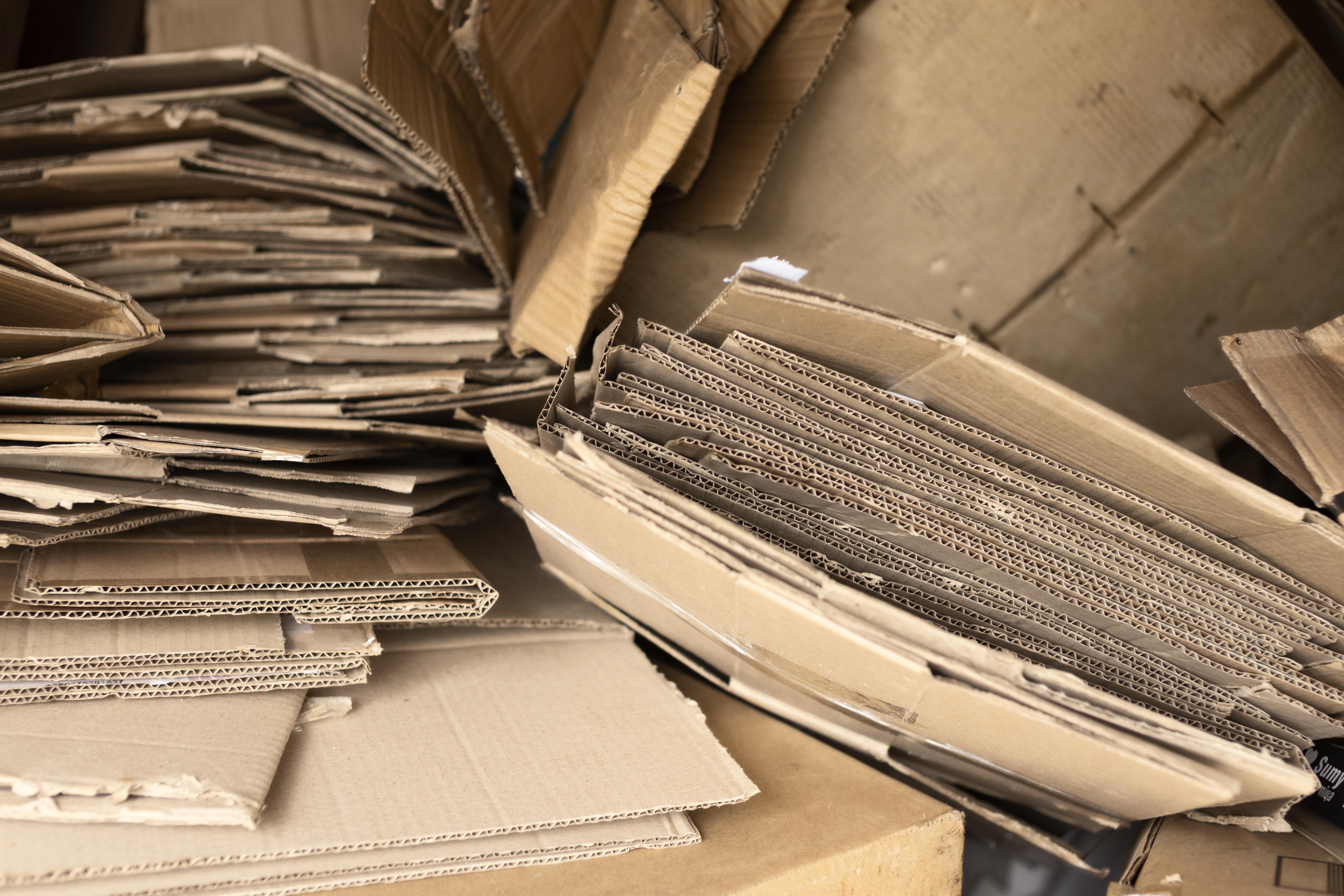 Close-up of flattened, worn corrugated cardboard showing the risks of flawed custom box packaging design.
